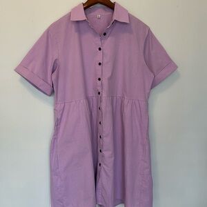 Adorable cotton dress. Purple short sleeves with pockets and ruffled back detail
